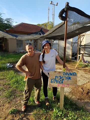 Image may contain: 2 people, people smiling, people standing, sky, tree, plant, outdoor and nature